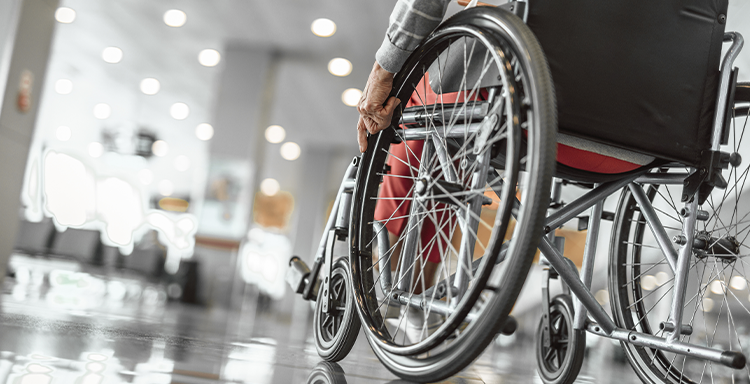 slanted perspective of older woman using a wheelchair at hospital or doctor's office - Springfield, IL