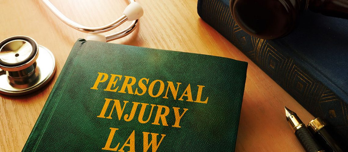 A personal injury law book on a table with a variety of legal items found in an attorney’s office in Springfield, IL.